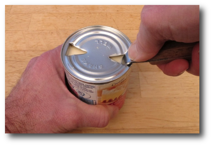 Opening a can of evaporated milk with a can opener
