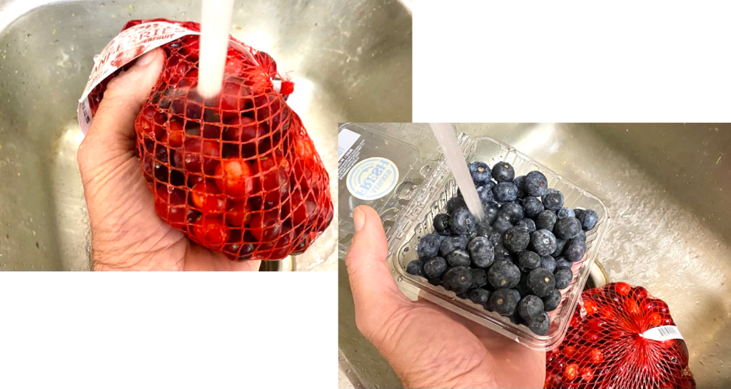 Rinsing fresh cranberries, blueberries and blackberries right in the containers the came in from the store.