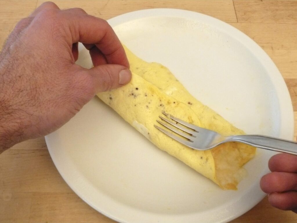 Microwave cheese omelet folded on white plate