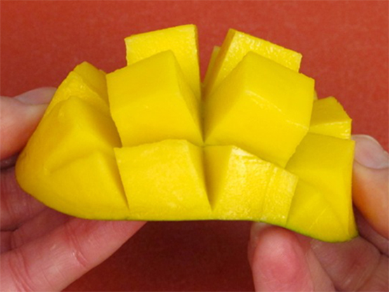 Chopped fresh mango with photo directions showing how to ripen and cut a mango